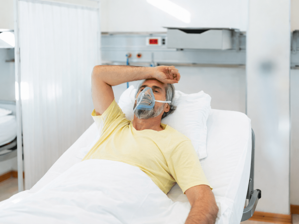 Paciente hospitalizado com máscara de oxigênio ilustra aumento das hospitalizações por influenza no Brasil em cenário de maior gravidade respiratória.